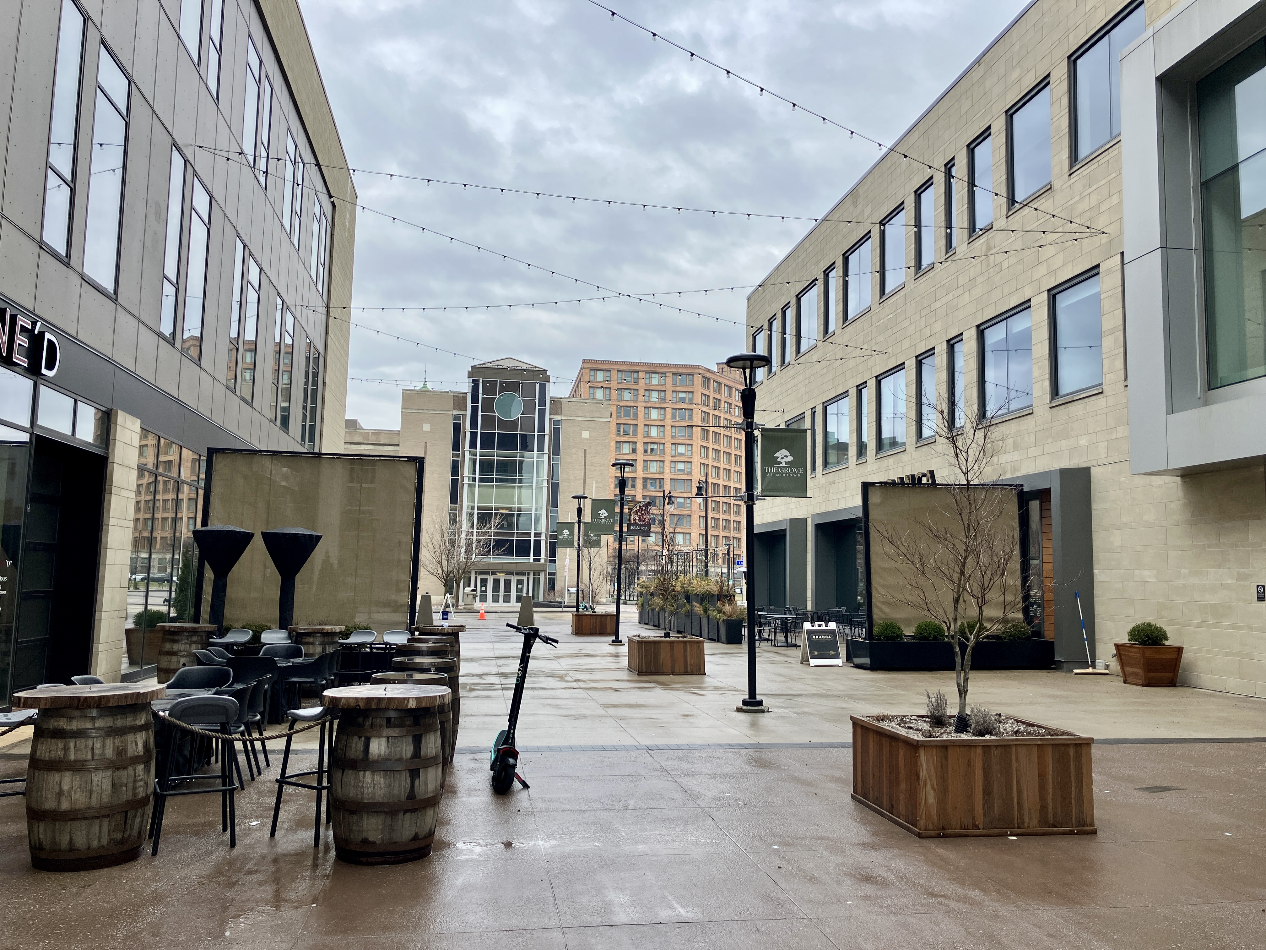 A stray scooter in an outdoor seating area.